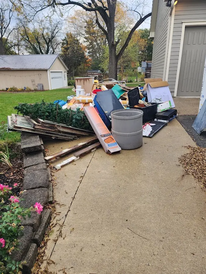 Dumpster being loaded with debris for Demolition Dumpster Rental in Oshkosh